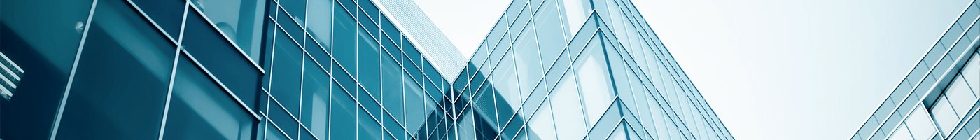 an exterior view of an office building with large glass windows