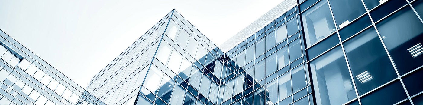 an exterior view of an office building with large glass windows