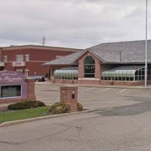 a commercial building with rounded glass windows and red brick exterior